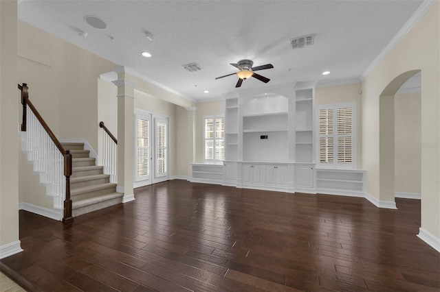 unfurnished living room with baseboards, visible vents, a textured ceiling, and hardwood / wood-style floors