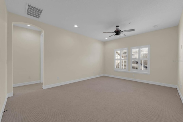 empty room featuring light carpet, baseboards, visible vents, a ceiling fan, and recessed lighting