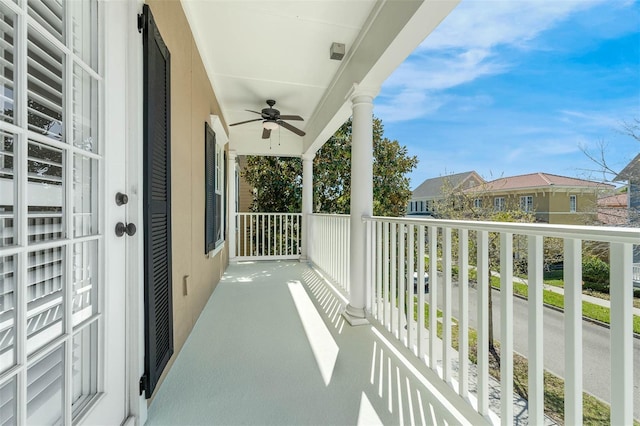 balcony featuring ceiling fan and a residential view