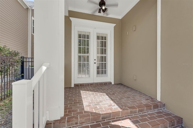 entrance to property featuring french doors and fence