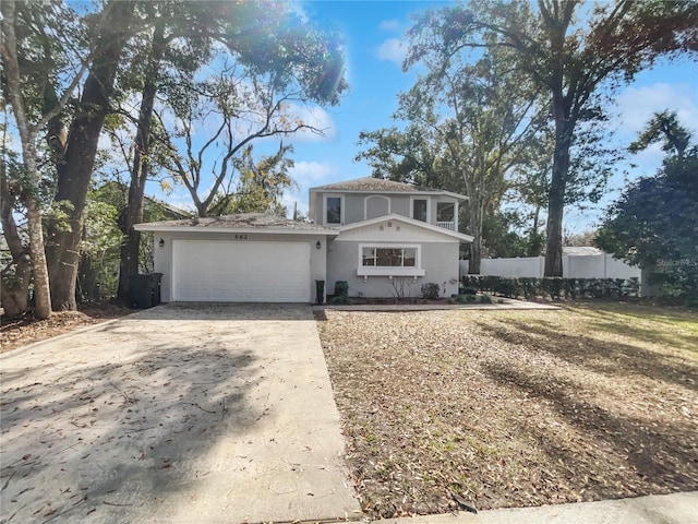 view of front facade with concrete driveway, an attached garage, and stucco siding