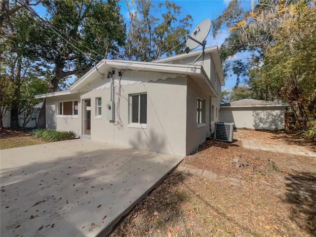 662 Lake Dr, Altamonte Springs, FL 32701 - view of property exterior with central AC, a patio, and stucco siding