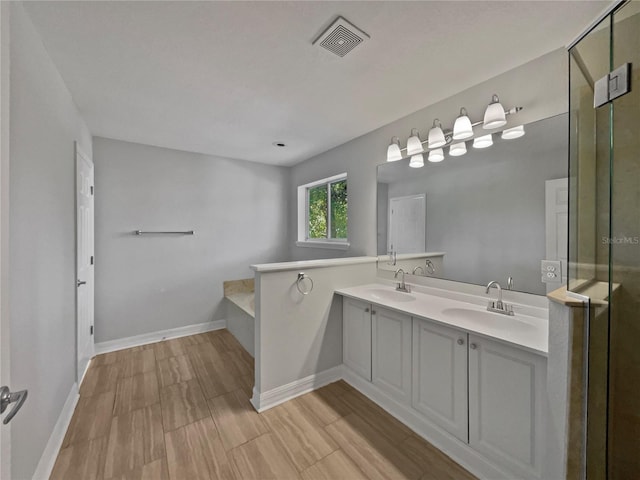662 Lake Dr, Altamonte Springs, FL 32701 - full bath with double vanity, visible vents, a sink, and a bath