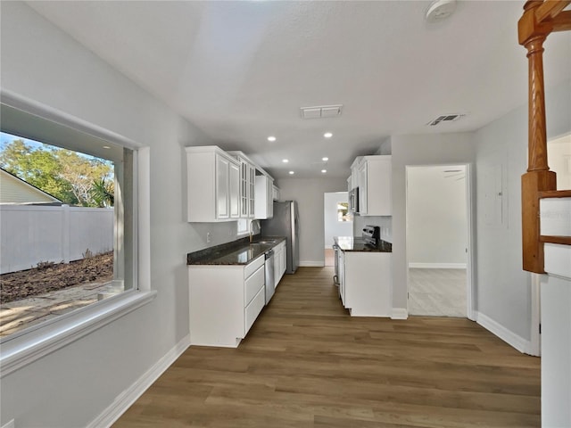 662 Lake Dr, Altamonte Springs, FL 32701 - kitchen with stainless steel appliances, visible vents, dark wood-type flooring, white cabinets, and a sink