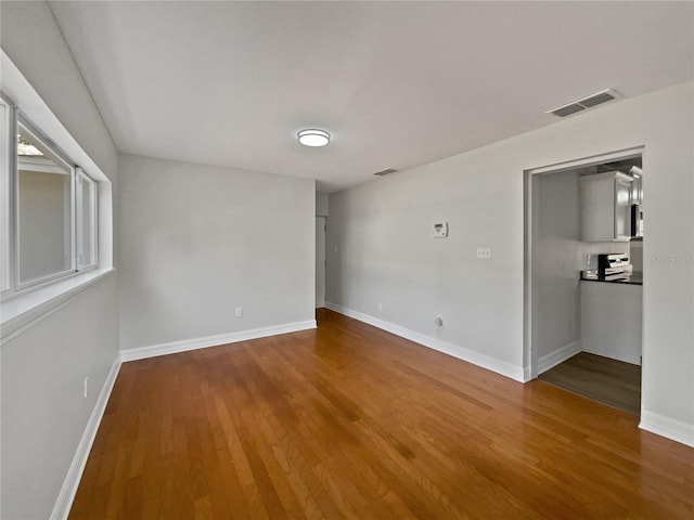 662 Lake Dr, Altamonte Springs, FL 32701 - spare room with wood finished floors, visible vents, and baseboards