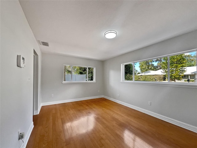 662 Lake Dr, Altamonte Springs, FL 32701 - unfurnished room with wood finished floors, visible vents, and baseboards