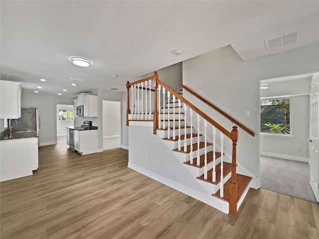 662 Lake Dr, Altamonte Springs, FL 32701 - stairs with recessed lighting, wood finished floors, visible vents, and baseboards