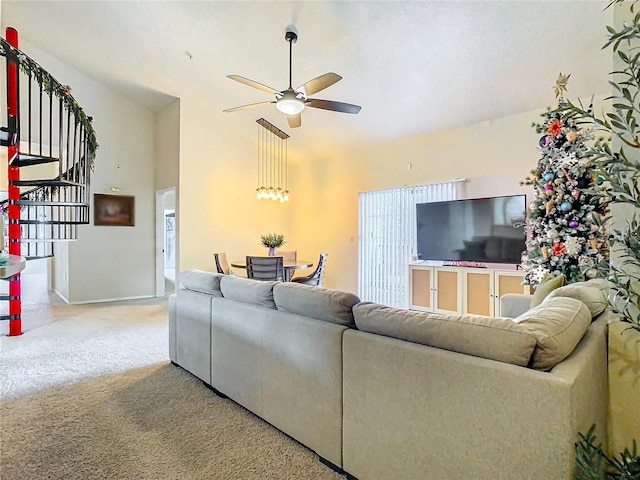 living room featuring a towering ceiling, carpet floors, and ceiling fan