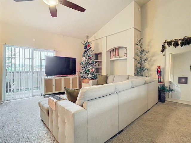 living room with light carpet, built in shelves, high vaulted ceiling, and ceiling fan