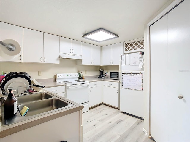 kitchen with white cabinetry, sink, white appliances, and light hardwood / wood-style flooring