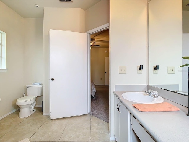 bathroom with tile patterned flooring, vanity, and toilet