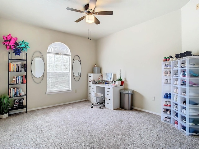 carpeted home office featuring ceiling fan