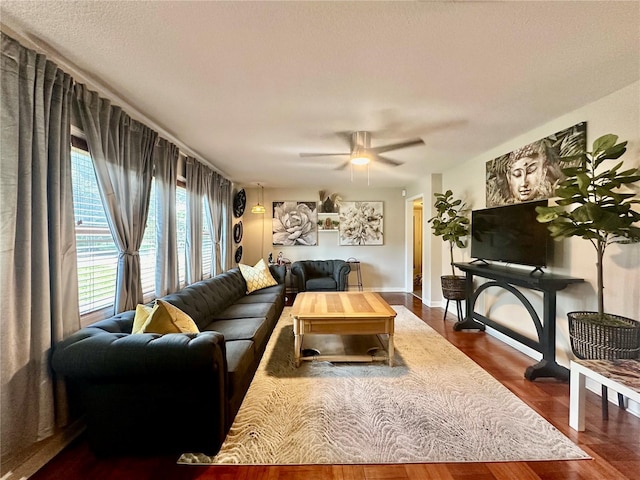 living room featuring dark hardwood / wood-style flooring and ceiling fan