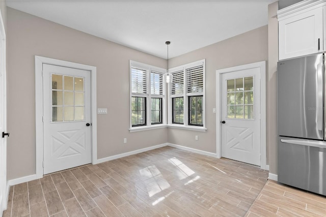 doorway to outside with wood tiled floor and baseboards