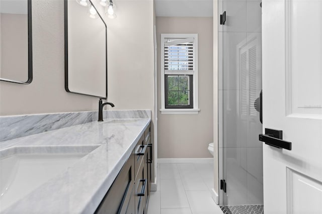 full bath featuring toilet, a sink, baseboards, tile patterned floors, and double vanity