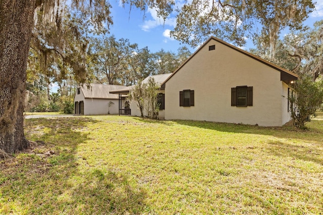 exterior space with a lawn and stucco siding