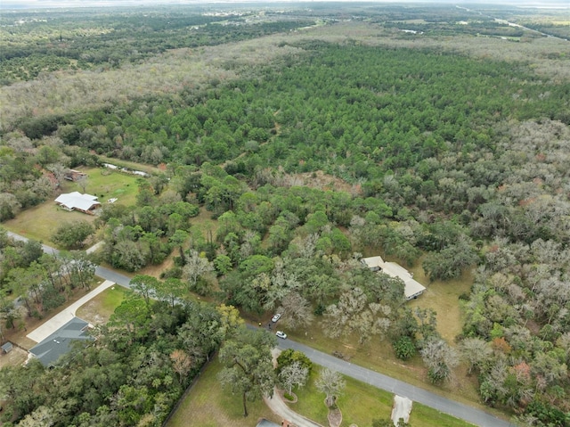 birds eye view of property with a view of trees
