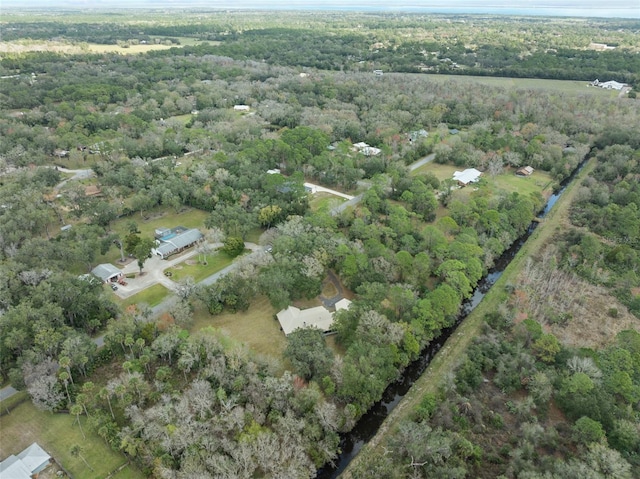 drone / aerial view featuring a wooded view