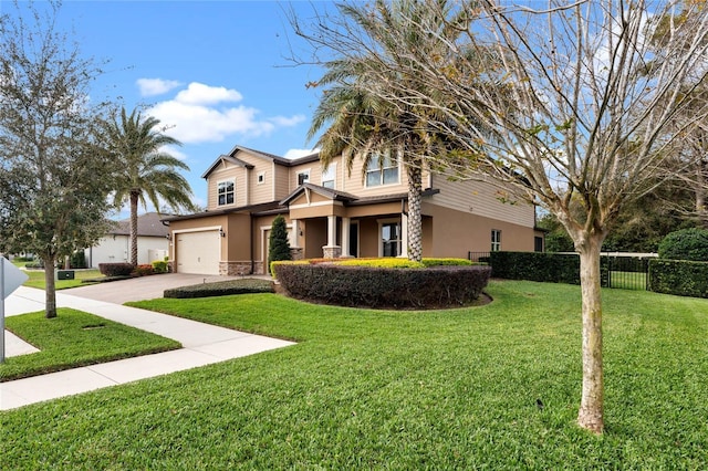 view of front of property with fence, a front lawn, stucco siding, a garage, and driveway