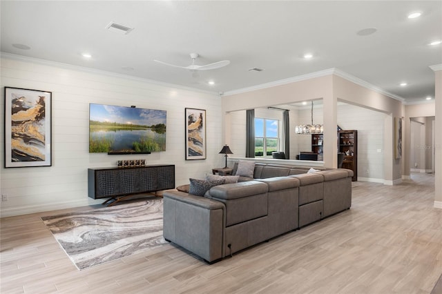 living area with visible vents, baseboards, light wood-style flooring, and ornamental molding