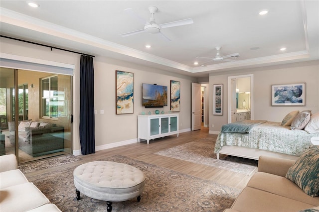 bedroom featuring a raised ceiling, recessed lighting, access to exterior, and light wood-style floors