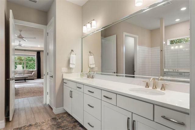 bathroom with double vanity, visible vents, wood tiled floor, and a sink