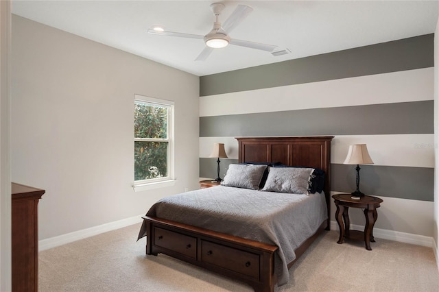 bedroom with baseboards, light colored carpet, visible vents, and ceiling fan