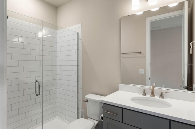 full bathroom featuring toilet, a stall shower, and vanity