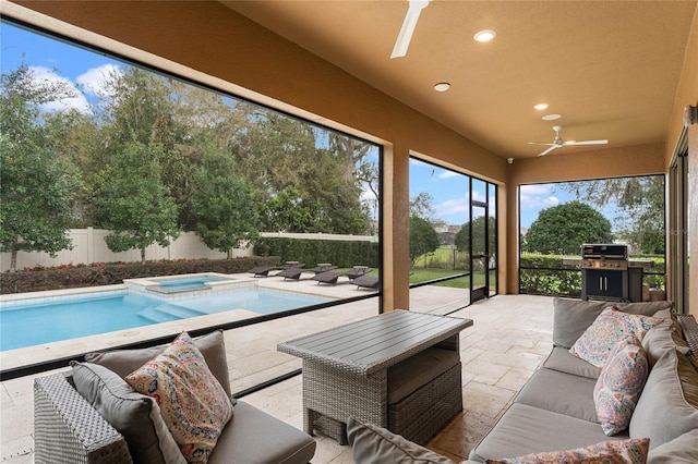 sunroom featuring a ceiling fan