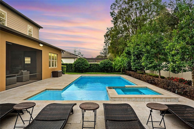 view of swimming pool featuring an in ground hot tub, a fenced in pool, a patio, and fence