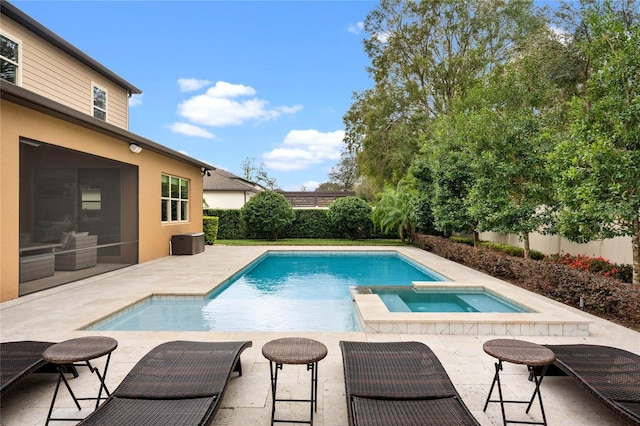 view of swimming pool with an in ground hot tub, a fenced in pool, a patio area, and fence