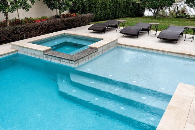 view of swimming pool featuring a patio area, fence, and a pool with connected hot tub