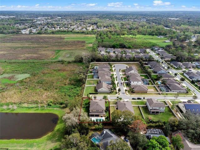 birds eye view of property with a water view and a residential view