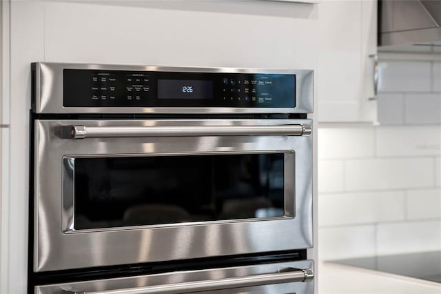 interior details with light countertops, white cabinets, and double oven