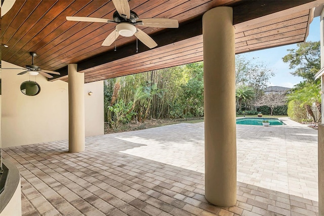 view of patio / terrace with ceiling fan and an outdoor pool