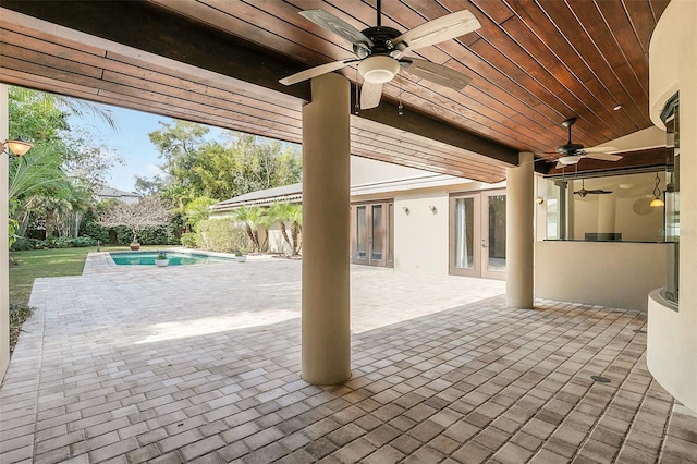 view of patio featuring a ceiling fan, french doors, and an outdoor pool