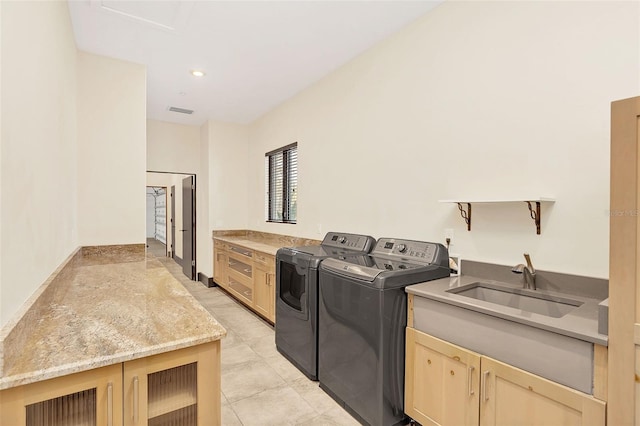 laundry room featuring recessed lighting, cabinet space, visible vents, a sink, and washer and dryer