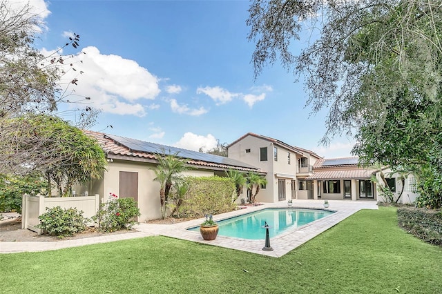 pool featuring fence, a patio, and a yard