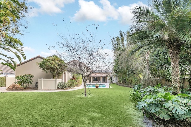 view of yard with an outdoor pool and fence