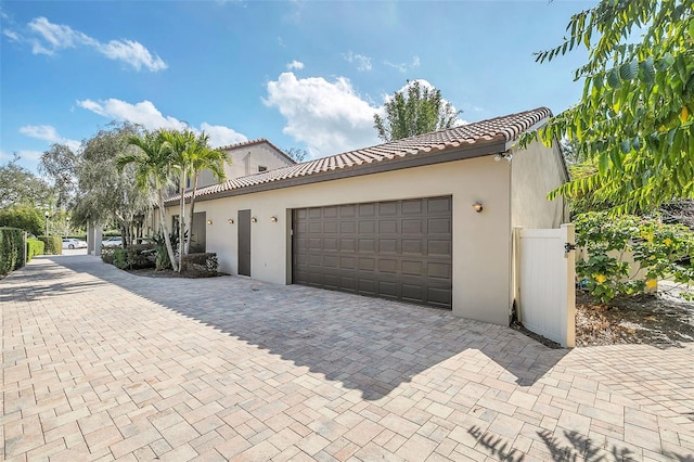 garage featuring decorative driveway