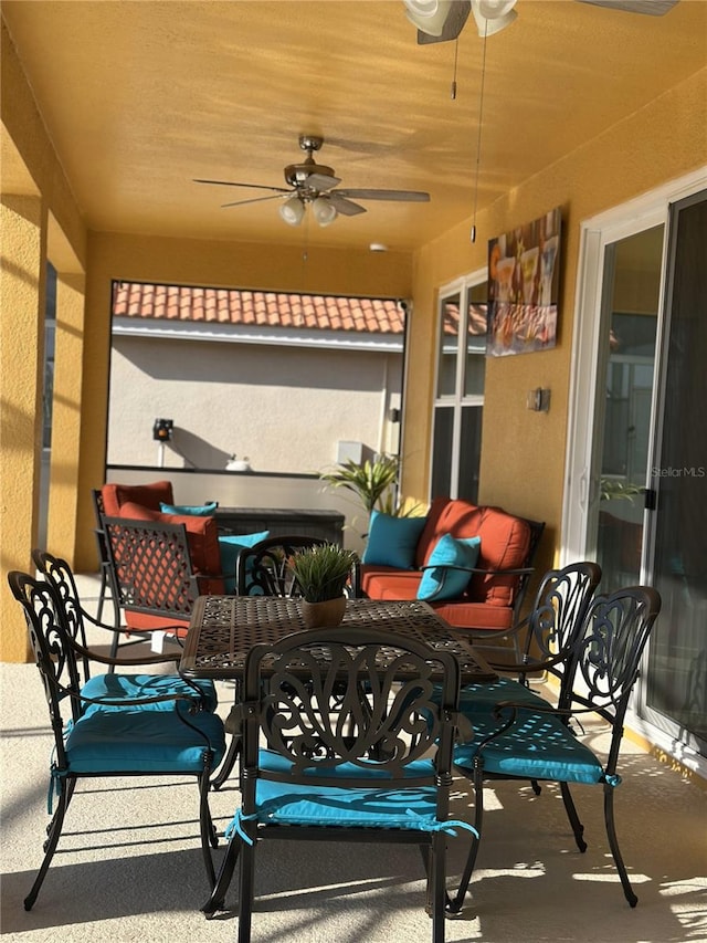 view of patio featuring a ceiling fan and outdoor dining space