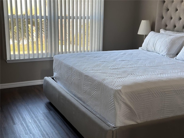 bedroom featuring dark wood-type flooring and baseboards