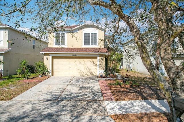 view of front of property with stucco siding, driveway, and an attached garage