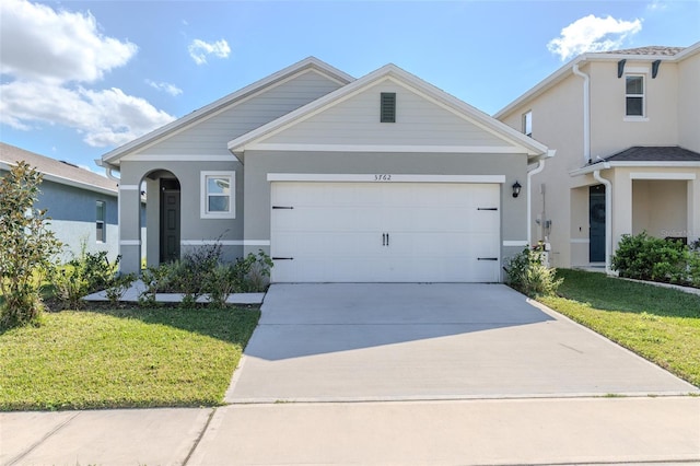 view of front of home featuring a garage and a front lawn