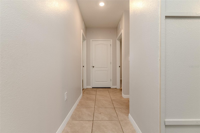 corridor featuring light tile patterned floors