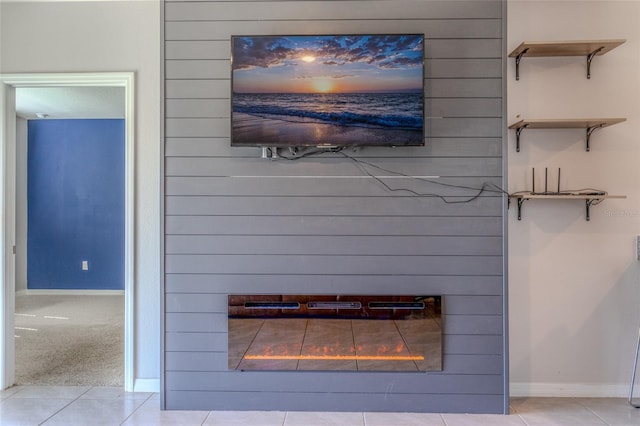 room details with wood walls, a large fireplace, and carpet