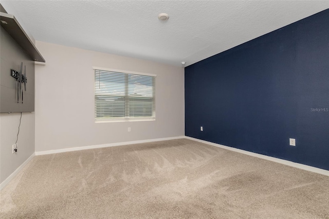 empty room featuring carpet floors and a textured ceiling