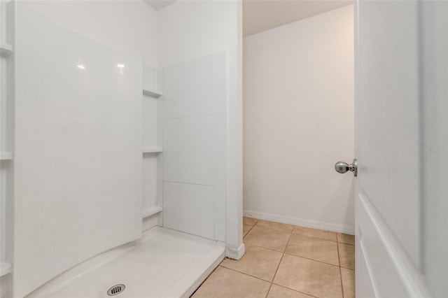 bathroom with walk in shower and tile patterned floors