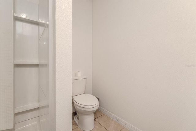 bathroom featuring tile patterned floors and toilet