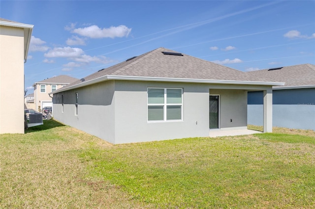 rear view of house featuring a yard